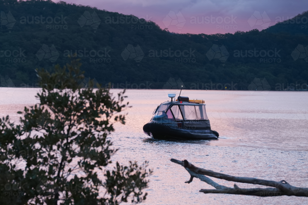 Water taxi at sunsent - Australian Stock Image