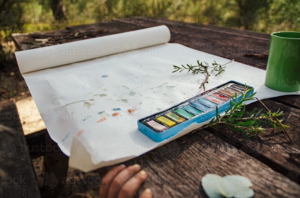 Watercolour painting at a picnic table - Australian Stock Image