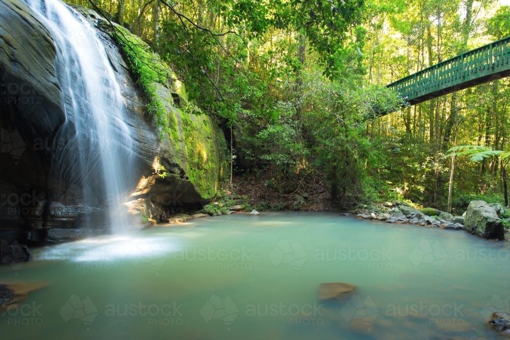 Waterfall and lagoon with bridge across - Australian Stock Image