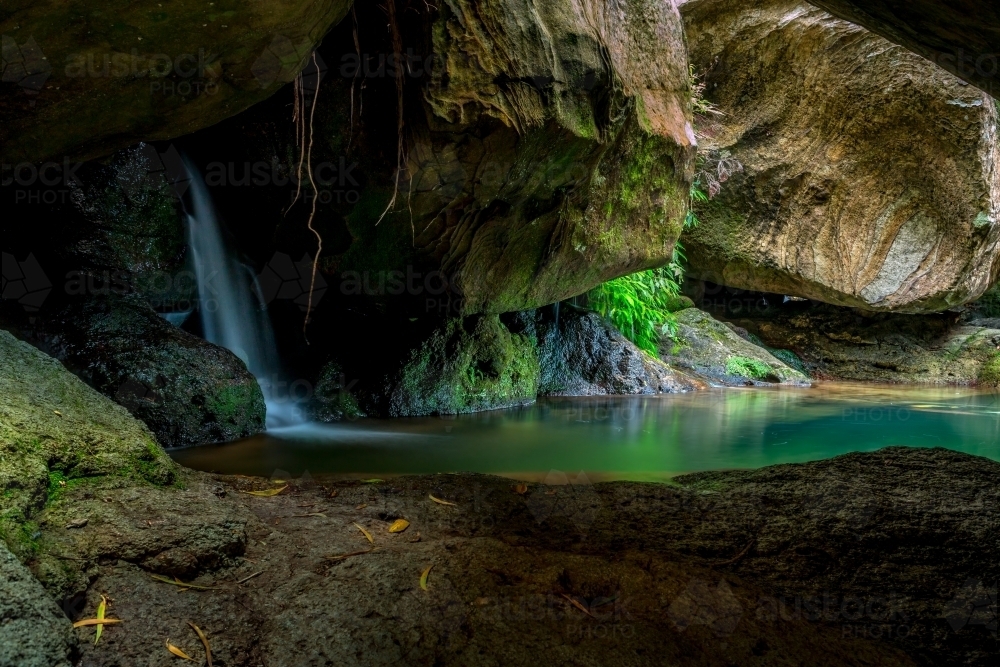 Waterfall and plunge pool paradise cave and rock texture patterns deep in the wilderness - Australian Stock Image