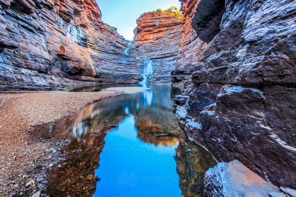 Waterfall and pool at bottom of rocky gorge - Australian Stock Image