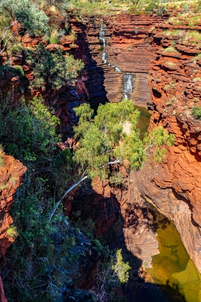 Waterfall and river flowing through rocky gorge : Austockphoto Waterfall and river flowing through rocky gorge - Australian Stock Image