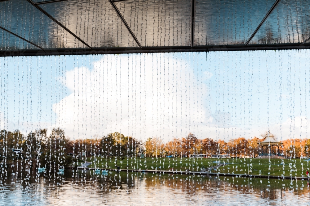 Waterfall water feature at end of The Riverbank Precinct Bridge on the Torrens River - Australian Stock Image