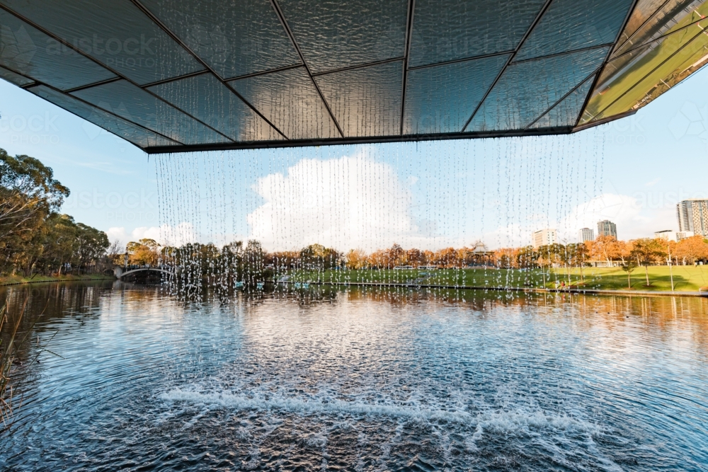 Waterfall water feature at end of The Riverbank Precinct Bridge on the Torrens River - Australian Stock Image