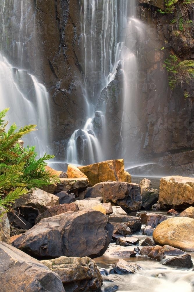 Image of Waterfall with rocks in foreground - Austockphoto