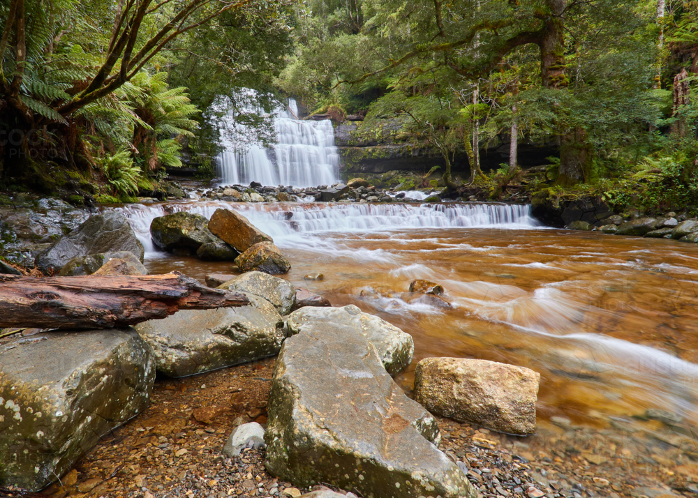 Waterfall with rocks in foreground. - Australian Stock Image