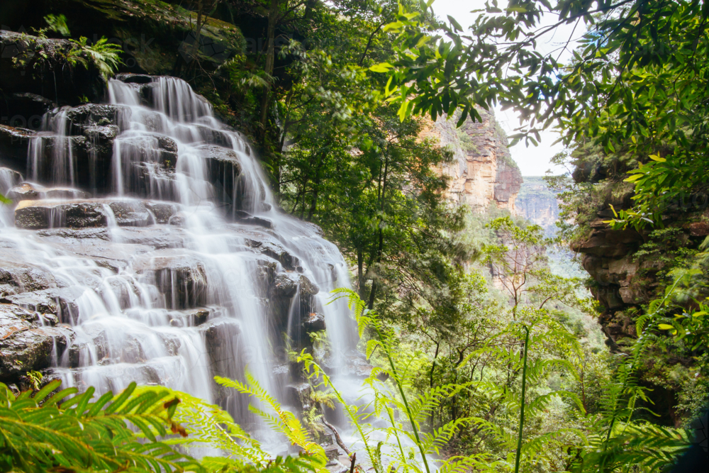 Waterfalls cascading over rocks in Wentworth Falls, New South Wales, Australia - Australian Stock Image