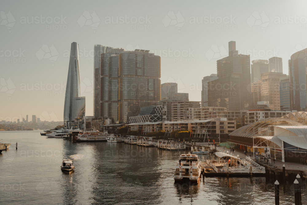 Waterfront city views of Darling Harbour, boats and Barangaroo at sunrise - Australian Stock Image