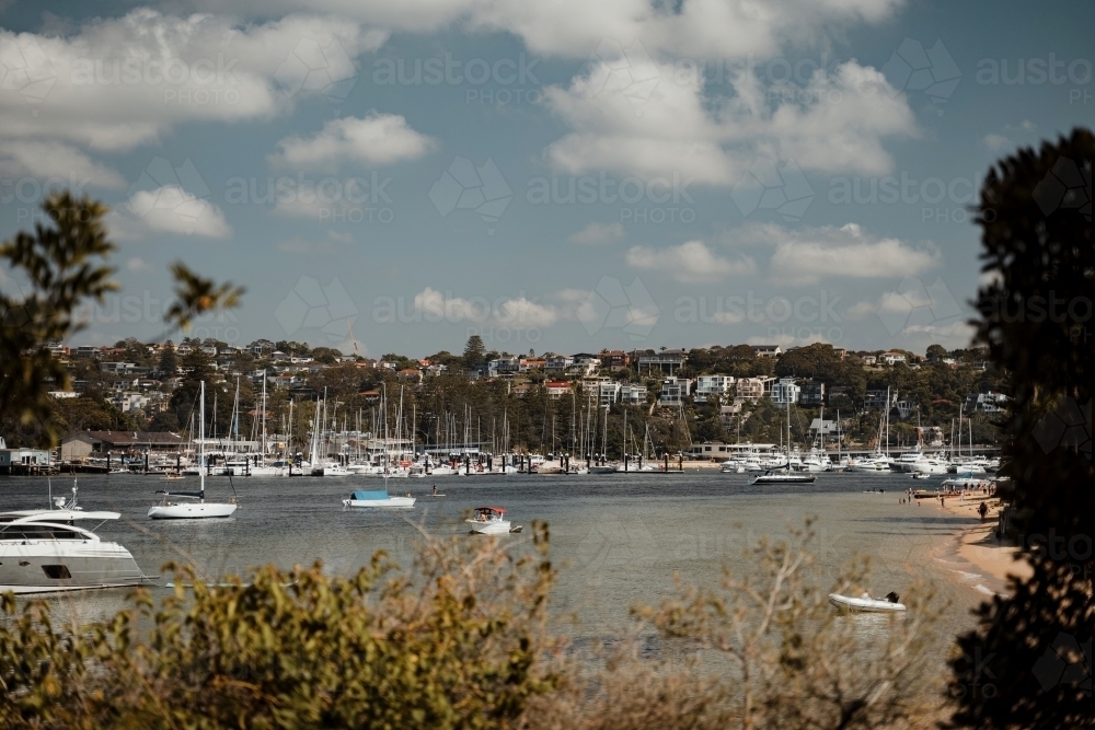 Waterfront properties, with yachts and boats around Clontarf Beach as seen from Spit to Manly Walk - Australian Stock Image