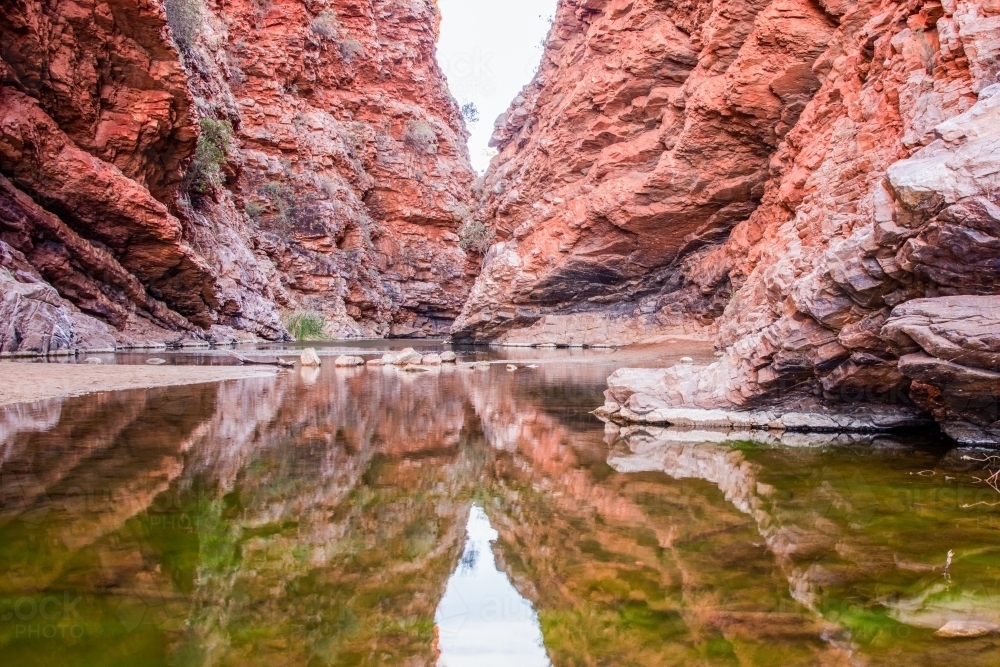 Waterhole showing reflection of rock - Australian Stock Image