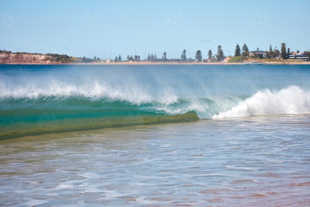 Wave breaking at beach - Australian Stock Image