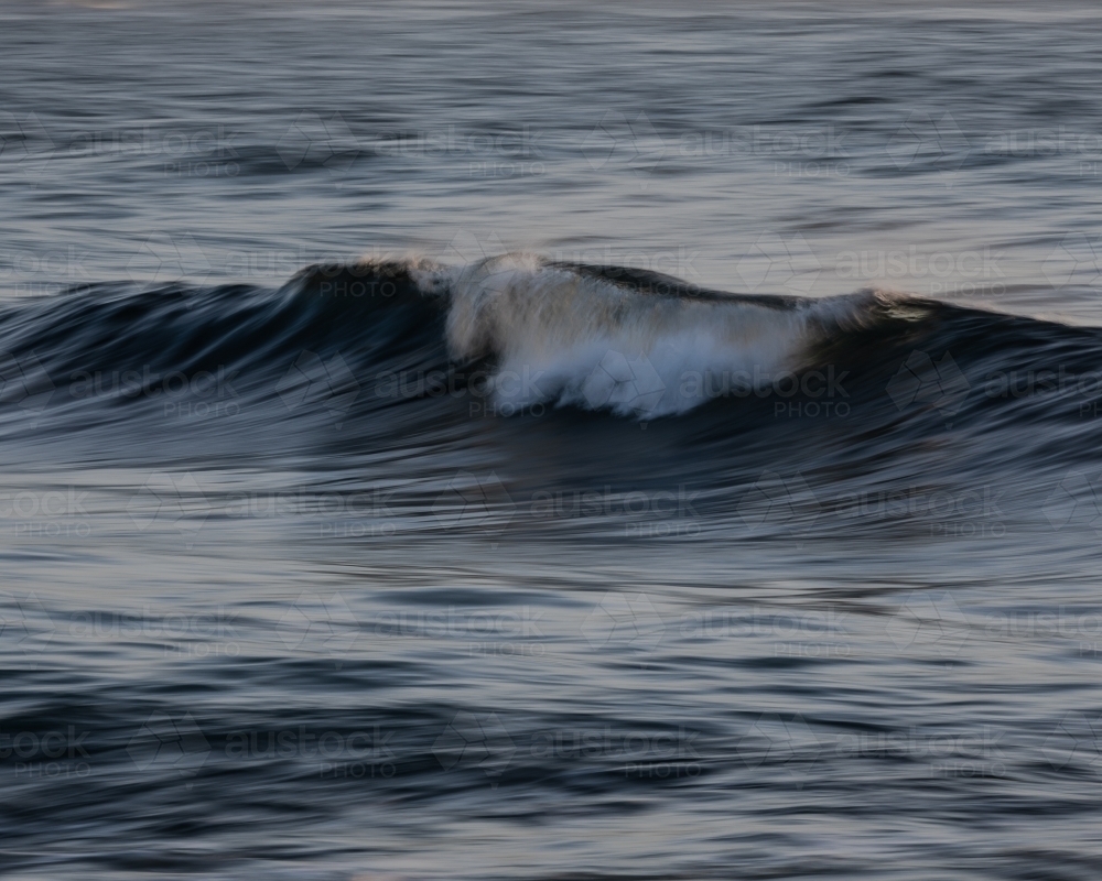 Wave breaking in simple scene - Australian Stock Image