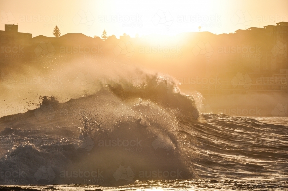 Waves against sunset - Australian Stock Image