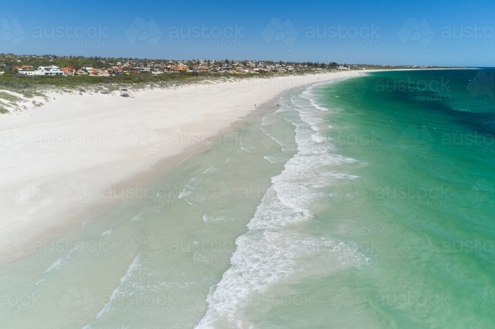 Waves and sand at Mullaloo Beach in Perth, Western Australia on a sunny day. - Australian Stock Image