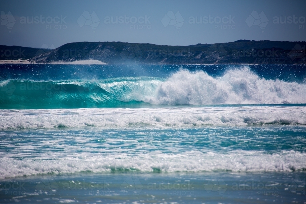 Waves breaking on deserted beach - Australian Stock Image