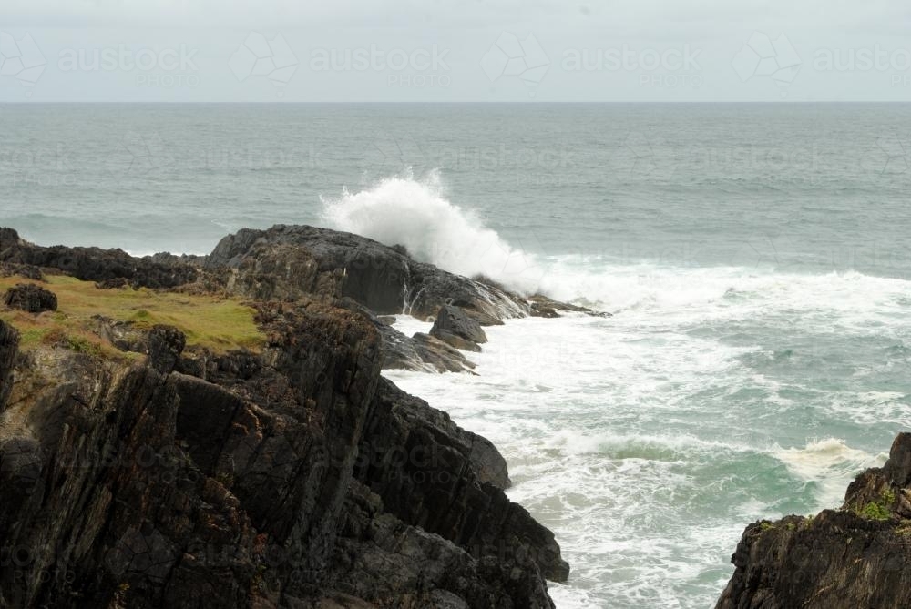 Waves breaking on rocks - Australian Stock Image