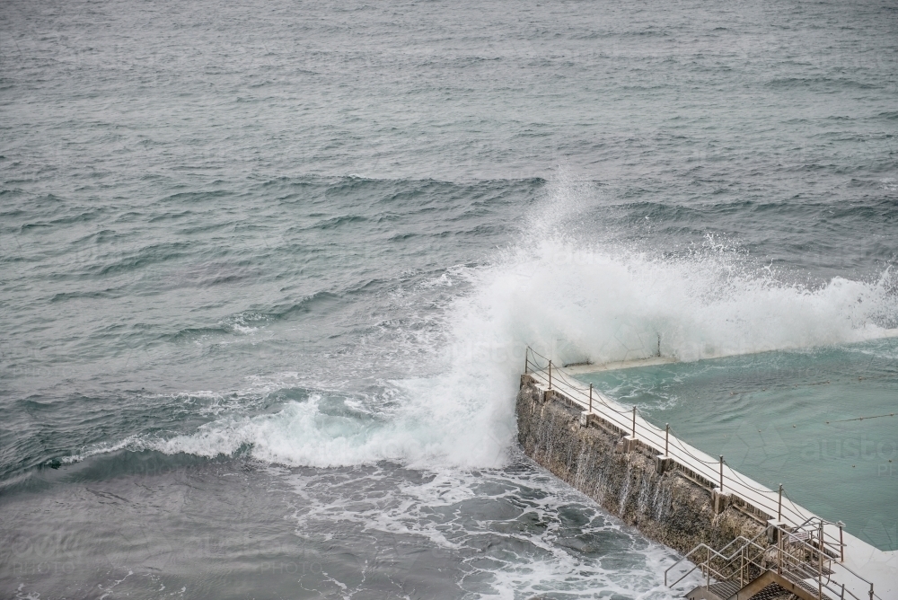 Waves breaking over seaside pool - Australian Stock Image