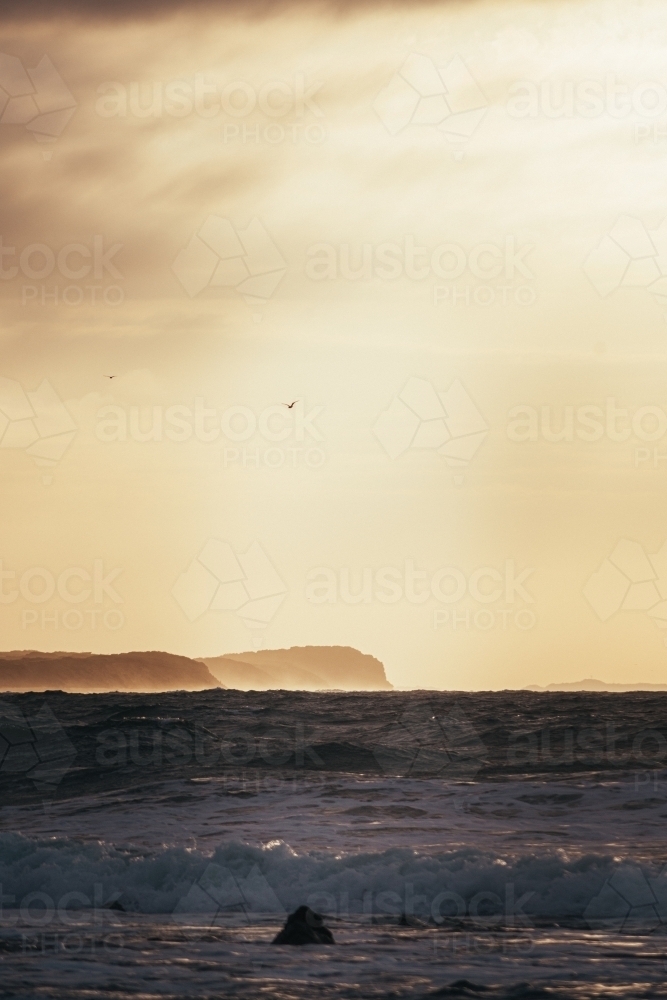 Waves, Cliffs, and a Cloudy Sunrise - Australian Stock Image