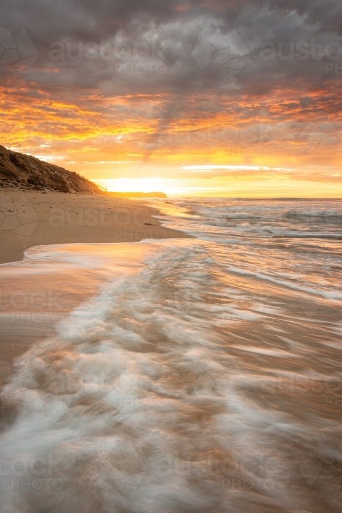 Waves Crashing during Sun Rise at a Quiet Local Beach - Australian Stock Image