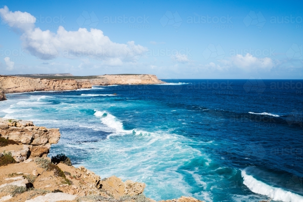 Waves crashing in to rocky headland - Australian Stock Image