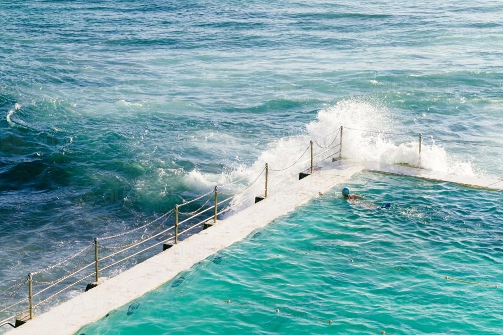 Waves crashing over the edge of Bondi Baths - Australian Stock Image