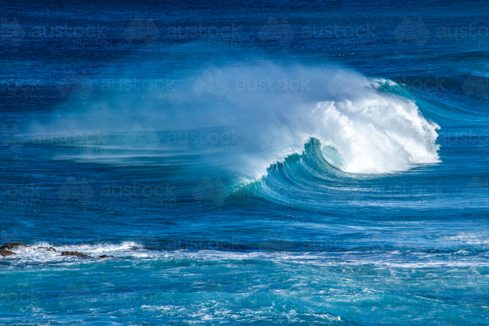 Waves curling, breaking, and frothing - Australian Stock Image