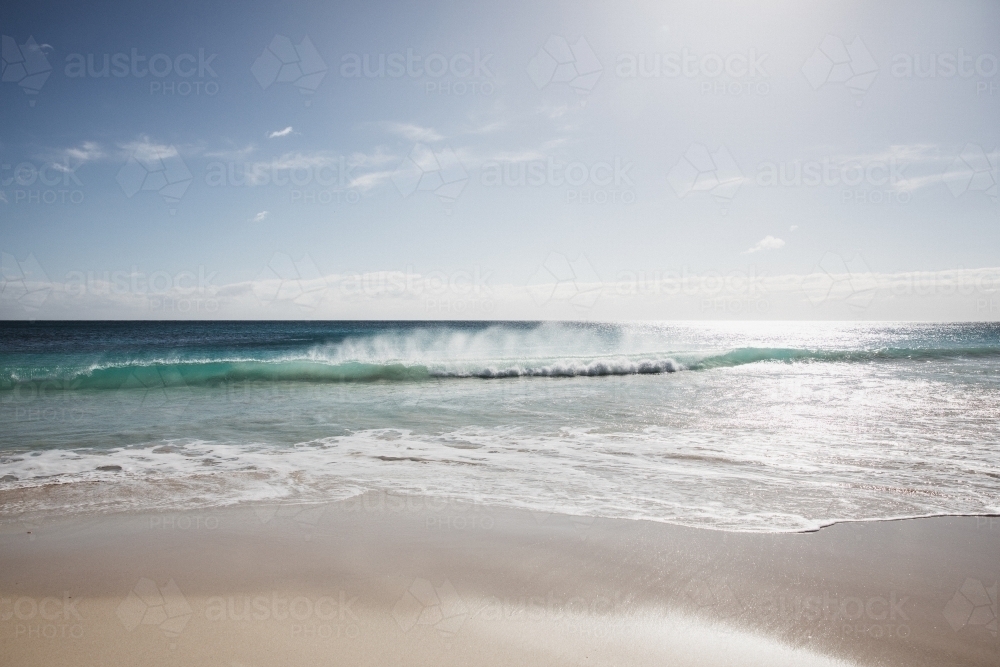 Waves on beach in morning light - Australian Stock Image