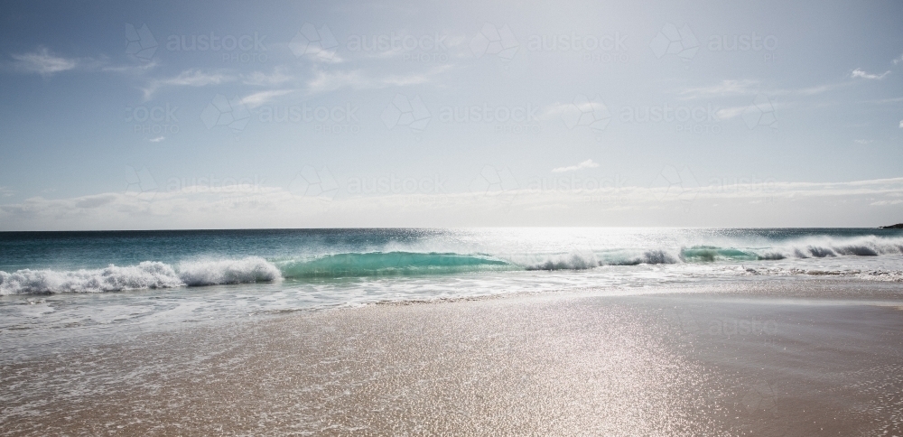 Waves on beach in morning light - Australian Stock Image