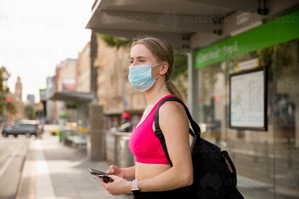 Wearing a Mask Waiting for the Tram - Australian Stock Image