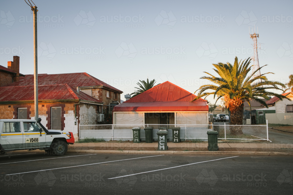 Weather board house and pub at sunset in Cue Western Australia - Australian Stock Image