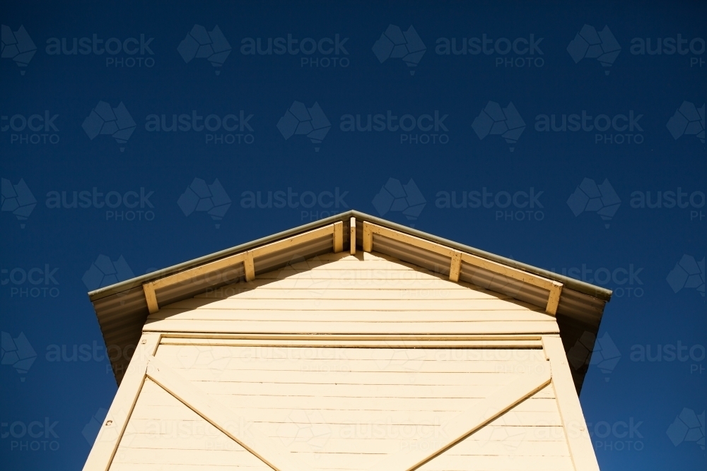 Weatherboard hut against a bright blue sky - Australian Stock Image