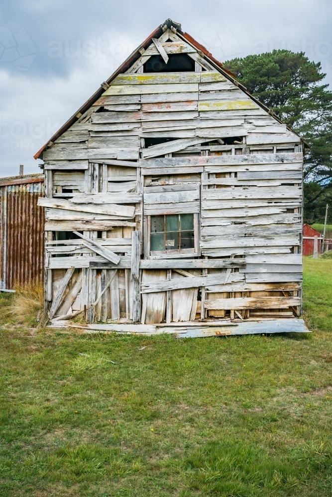 Weatherboards falling off an old wooden shed - Australian Stock Image
