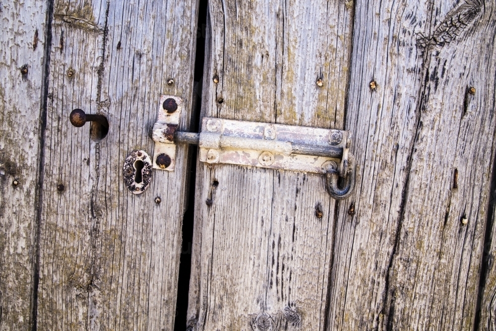 Weathered timber door with hasp - Australian Stock Image
