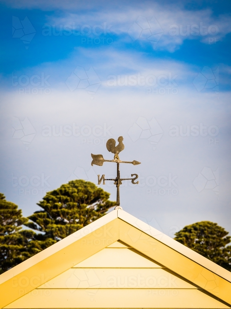 Weathervane on a gable roof. - Australian Stock Image