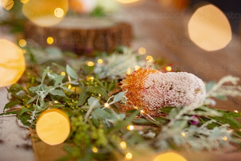 Wedding table centrepiece decorations made with gum leaves and native flowers - Australian Stock Image