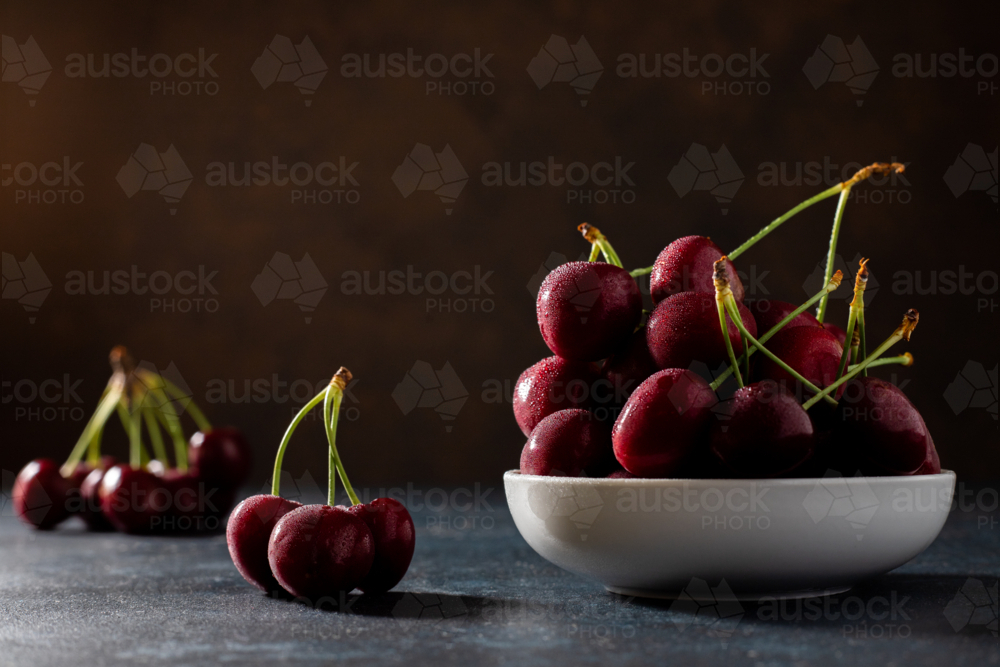 wet red cherries on a plate - Australian Stock Image