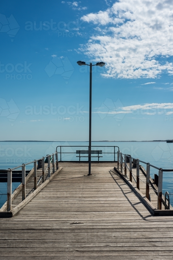 Wharf in still blue water - Australian Stock Image