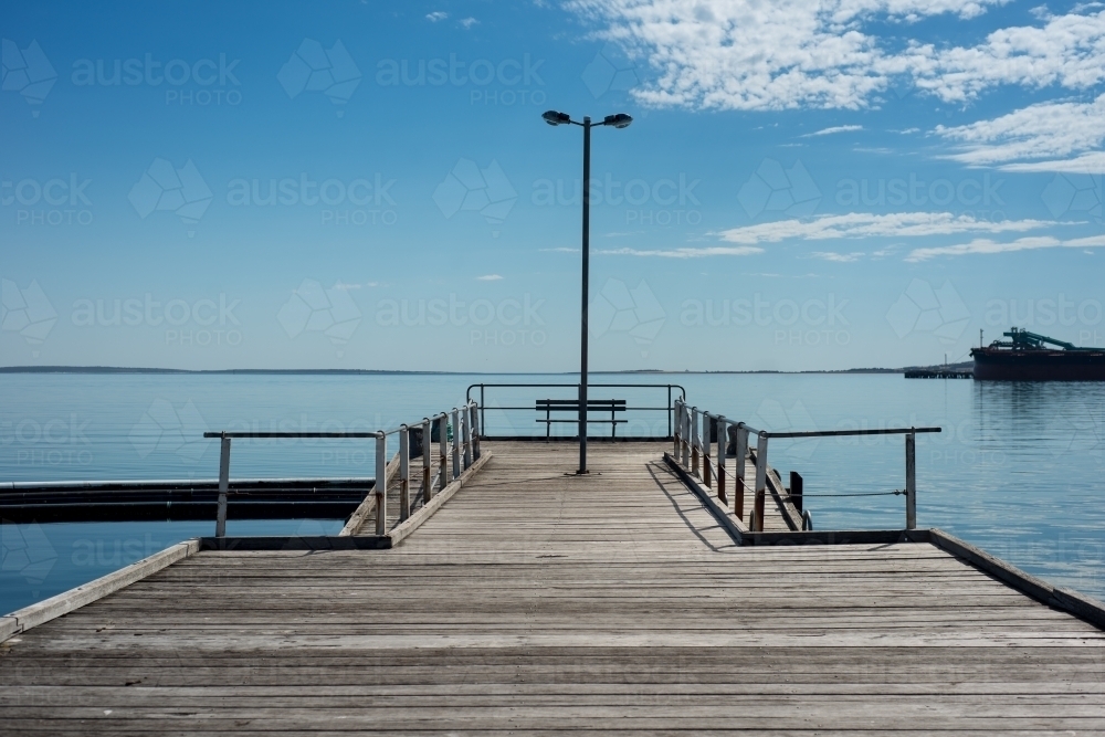 Wharf over still blue water - Australian Stock Image