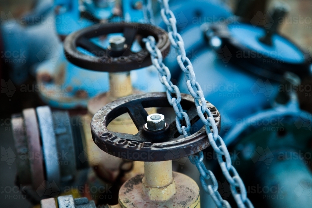 Wheels and chains on a blue water hydrant - Australian Stock Image