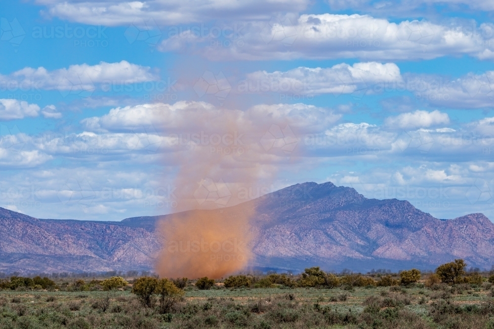 whirlwind on plains with rugged hills - Australian Stock Image