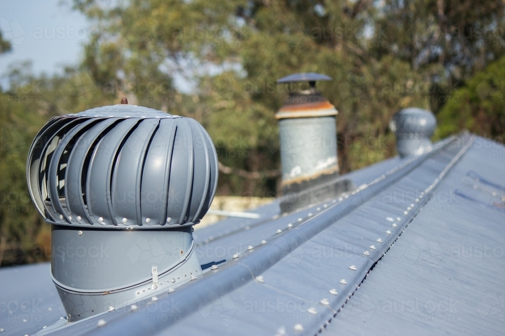 Whirlybird roof vents on tin roof - Australian Stock Image