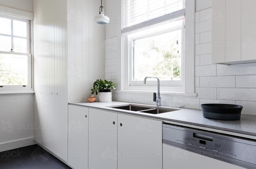 White and charcoal new renovated galley style Australian apartment kitchen - Australian Stock Image