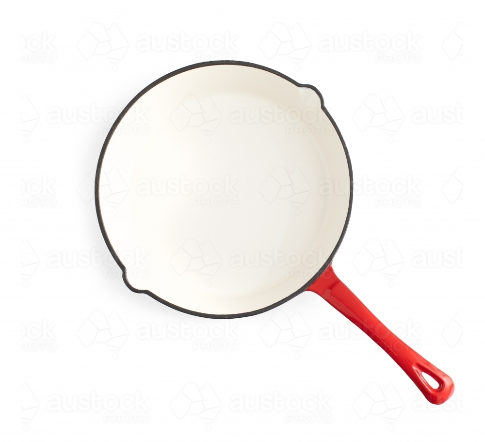 white and red frying pan on white background - Australian Stock Image