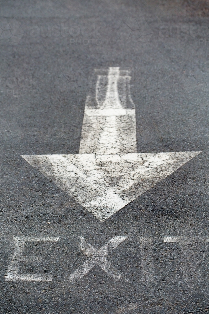 White arrow painted on bitumen road - Australian Stock Image
