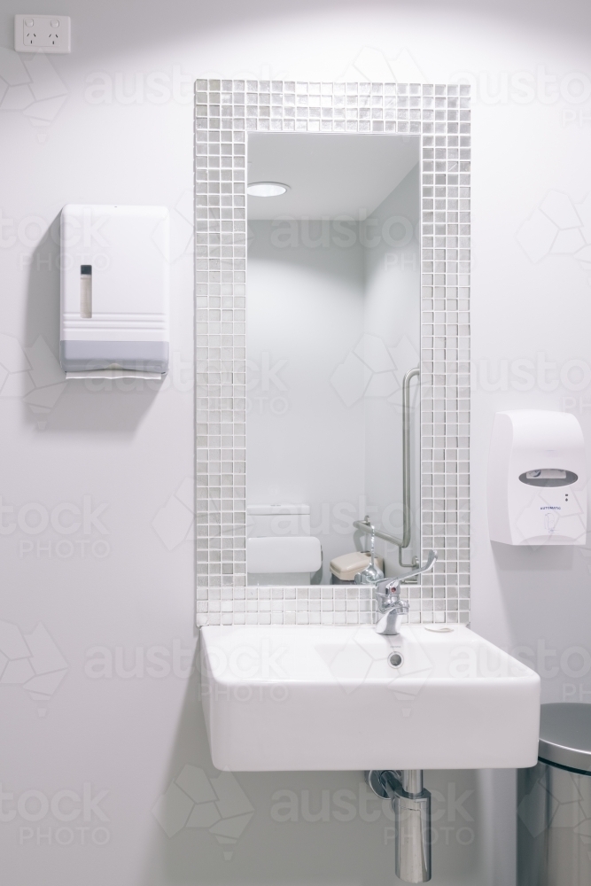 White basin in modern public bathroom - Australian Stock Image