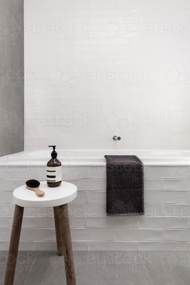White bath hob and stool with soap day spa bathroom - Australian Stock Image