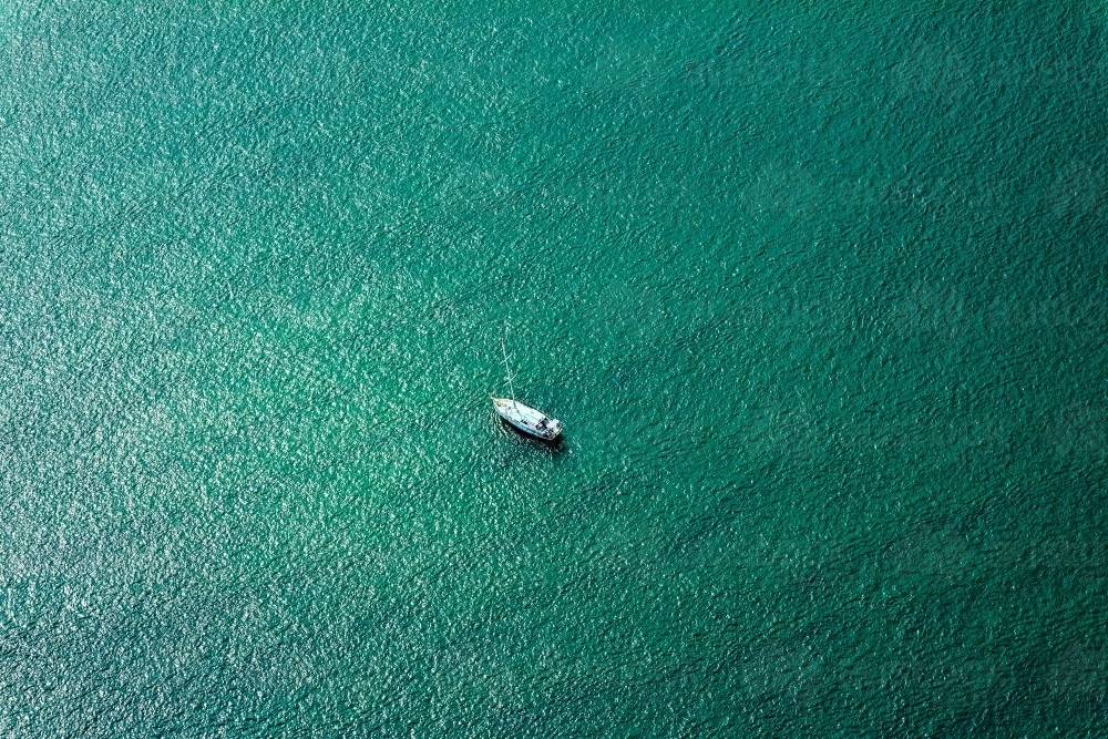 white boat moored in sea green water - Australian Stock Image