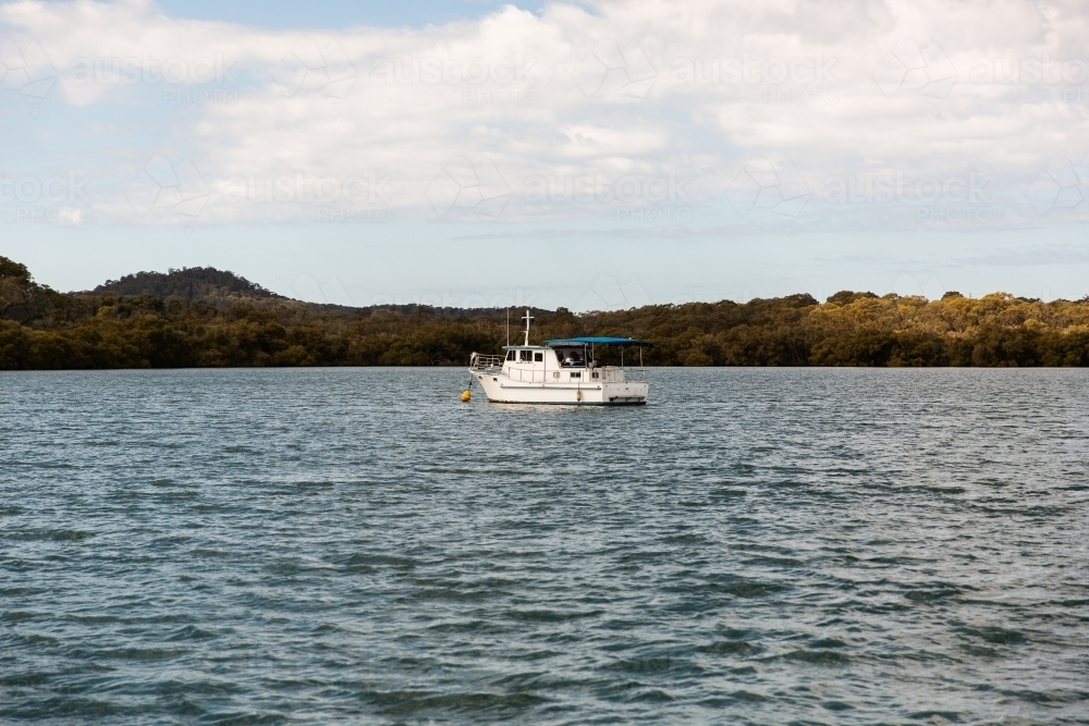white boat moored on Moreton Bay - Australian Stock Image