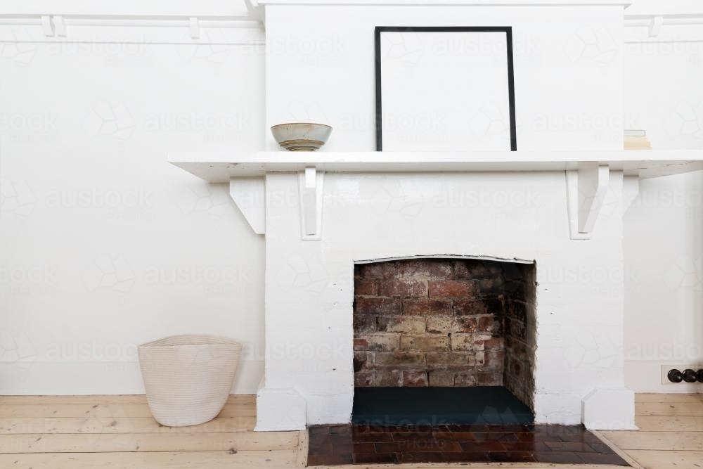 White brick fire place in vintage styled living room interior - Australian Stock Image