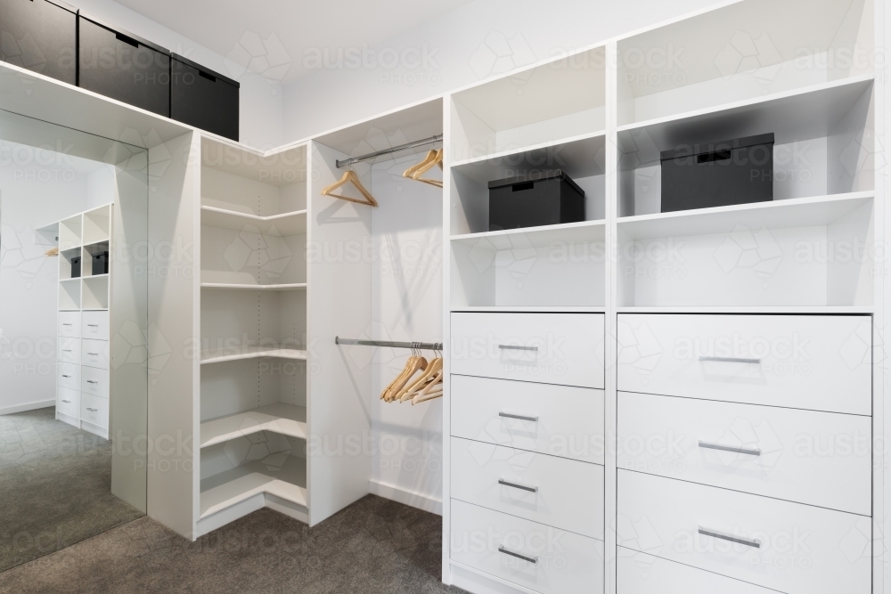 White built in storage in large walk in wardrobe - Australian Stock Image